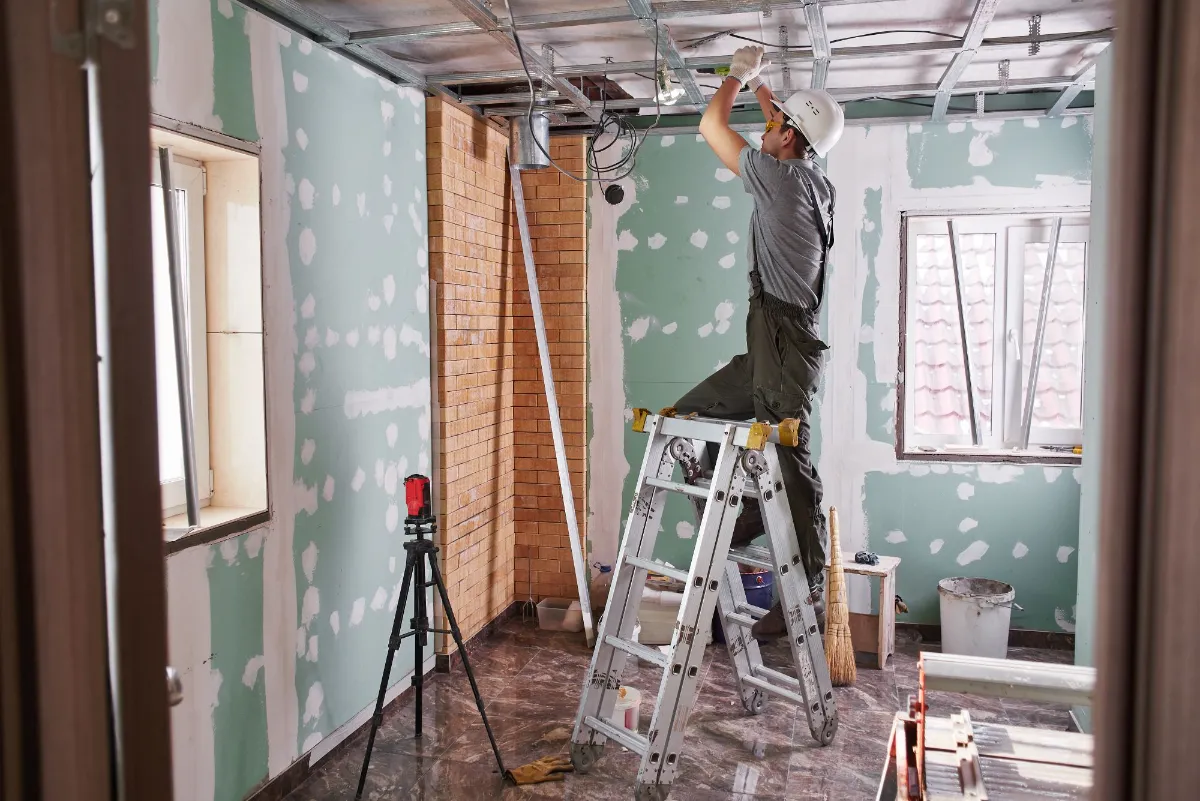 Electrician inspecting a construction site with tools on the floor, representing MT Electric’s reliable partnership with general contractors in Reno and Tahoe.