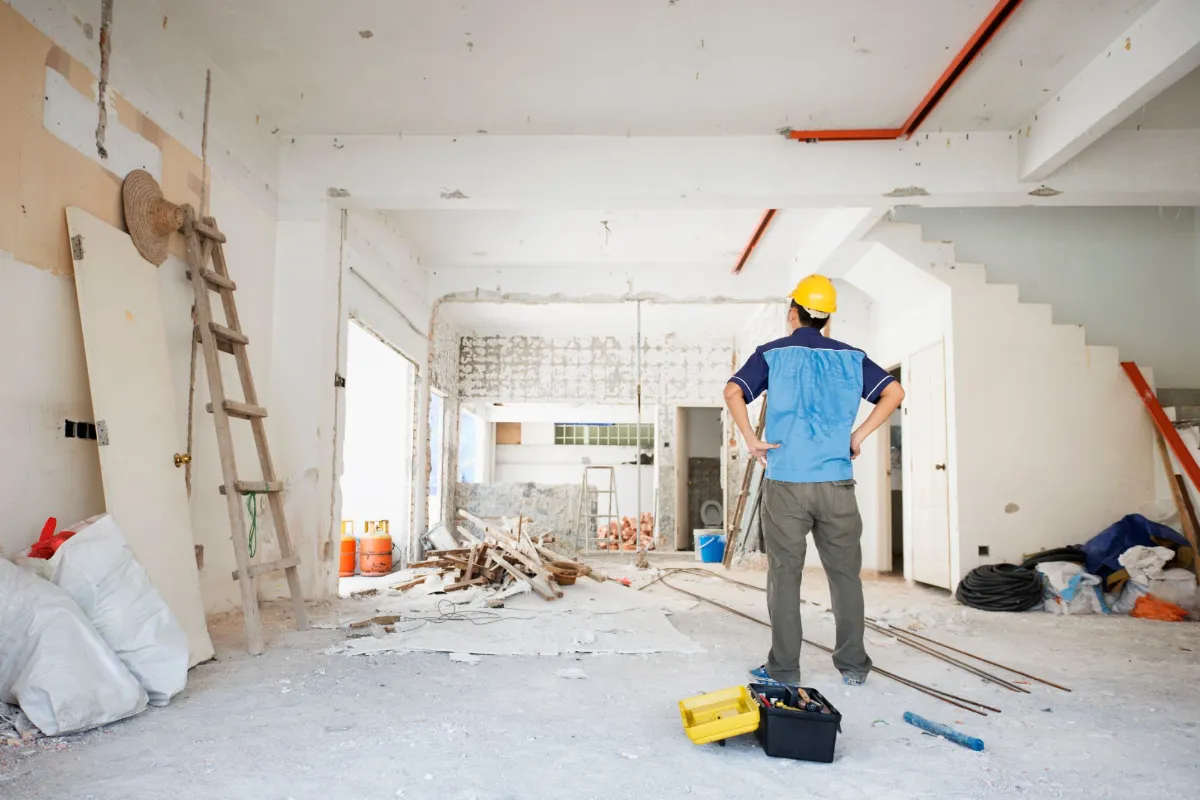 Electrician inspecting a construction site with tools on the floor, representing MT Electric’s reliable partnership with general contractors in Reno and Tahoe.