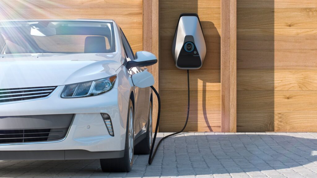 Electric vehicle charging at a modern wooden garage in Incline Village, Nevada.  