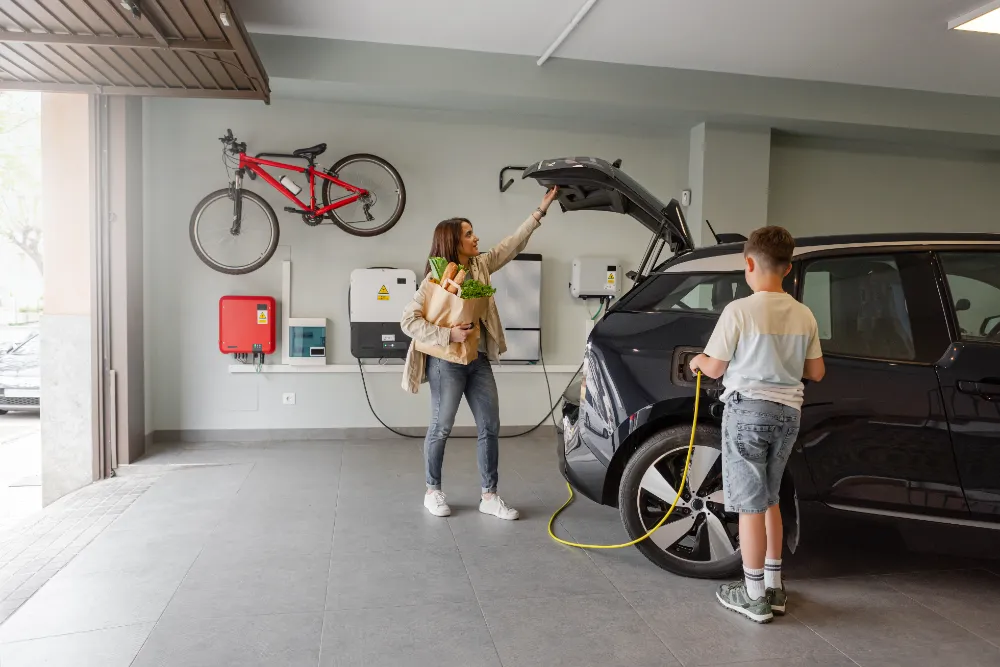 Family charging an electric vehicle inside a residential Minden, Nevada garage, showing a safe and convenient home EV setup.  