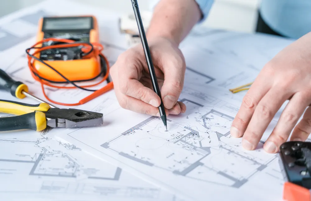 Electrical planning and blueprint review showing detailed layouts used to coordinate work on construction projects